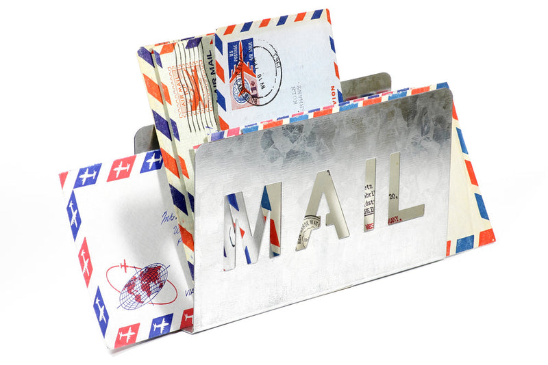 A metal mail holder with the word 'MAIL' cut out, filled with vintage airmail envelopes featuring red and blue borders. Image titled 'Candle Face Victim #25 and #26: Ghostly Correspondence,' a journal entry in Candle Face Chronicles.