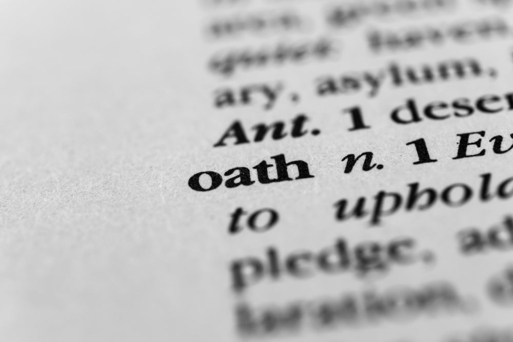 Close-up of the word “oath” in a dictionary, symbolizing the solemn promise each caretaker makes when accepting a scroll from the Scrolls of Souls—a vow to protect, remember, and never forget the voice sealed within.