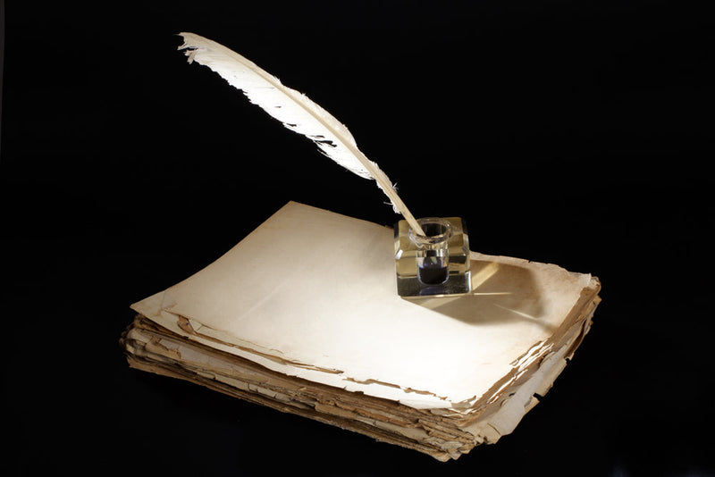 A stack of old parchment papers with a quill dipped in ink, symbolizing Mr. Smoe's magical manuscript and the countless stories sealed within.