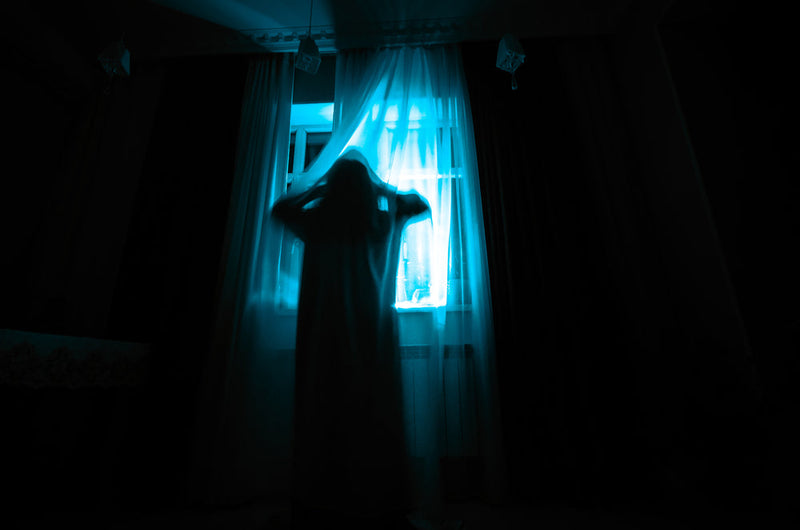 Candle Face, her skeletal form emerging from the darkness, her hollow eyes and open mouth frozen in a silent scream—watching, waiting, never forgotten.