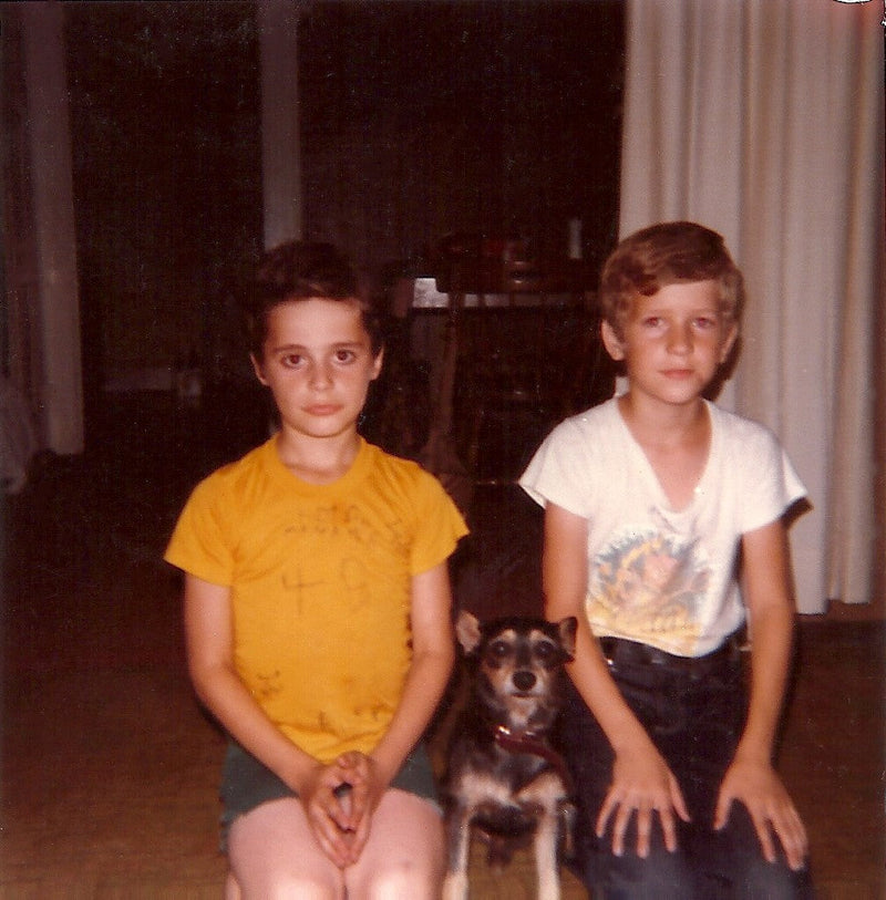 A childhood photo from The Empty Lot Next Door featuring Ricky, Ray (the author), and their dog, Tiny. A snapshot of the past tied to the haunting events described in the book.