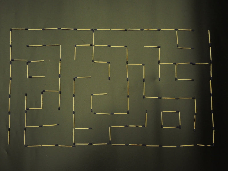 Matchstick maze symbolizing the twisted and complex path of identifying Candle Face’s victims. A visual puzzle representing the moral and ethical struggle featured in Candle Face Chronicles.