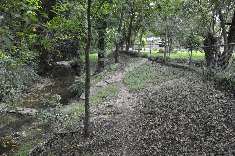 The creek from my old neighborhood, a place where many—including myself—have seen Candle Face. A quiet stretch of water hiding a much darker history.