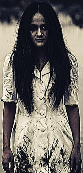 A haunting figure of a young woman with long, disheveled dark hair wearing a stained, white dress. Her expression is somber and scary, suggesting she is a lost soul seeking help. This image represents 'The Lost Soul from Bryan, Texas' from Candle Face Chr