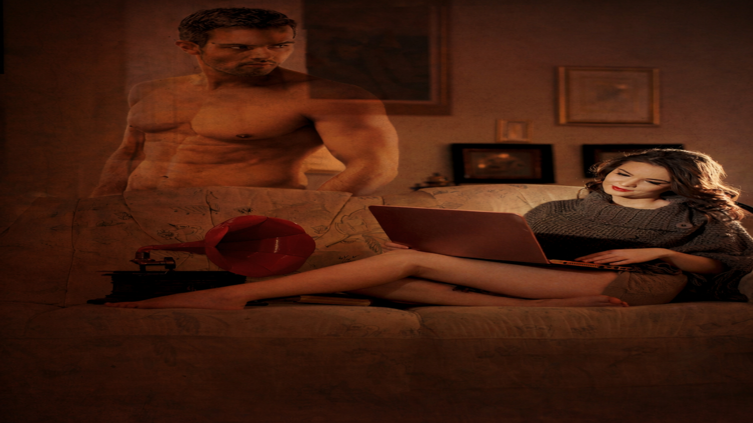 Man and woman in a dimly lit room with a laptop and red megaphone.