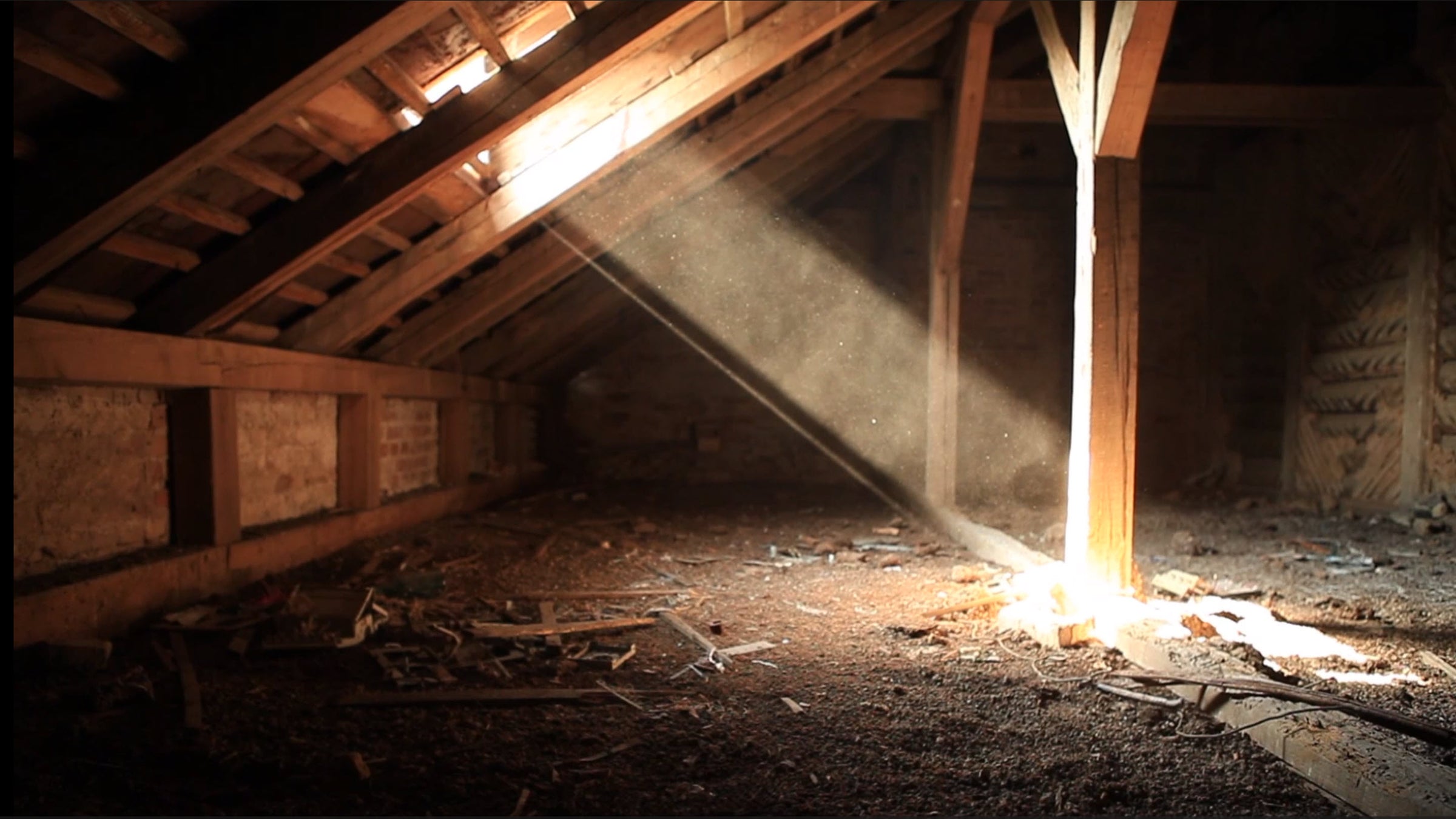 Dust-filled attic bathed in a single beam of light piercing through broken roof slats; this is where Mr. Smoe stored the forgotten scrolls—each one holding a silenced soul waiting to be remembered.