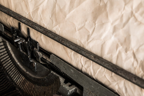 Close-up of an old typewriter on textured paper